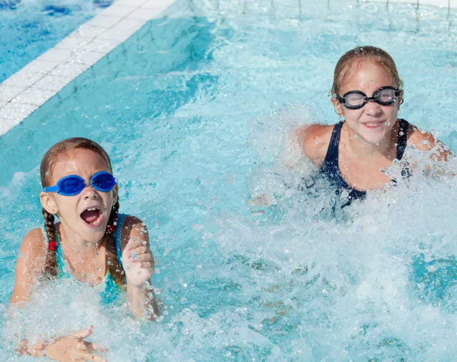 a couple of kids in a pool