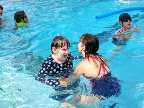 a group of children in a pool