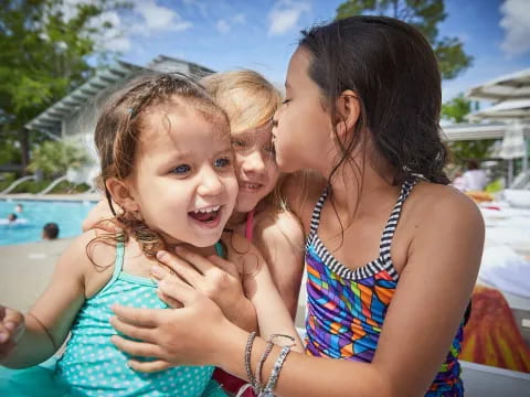 a person kissing a girl on the cheek