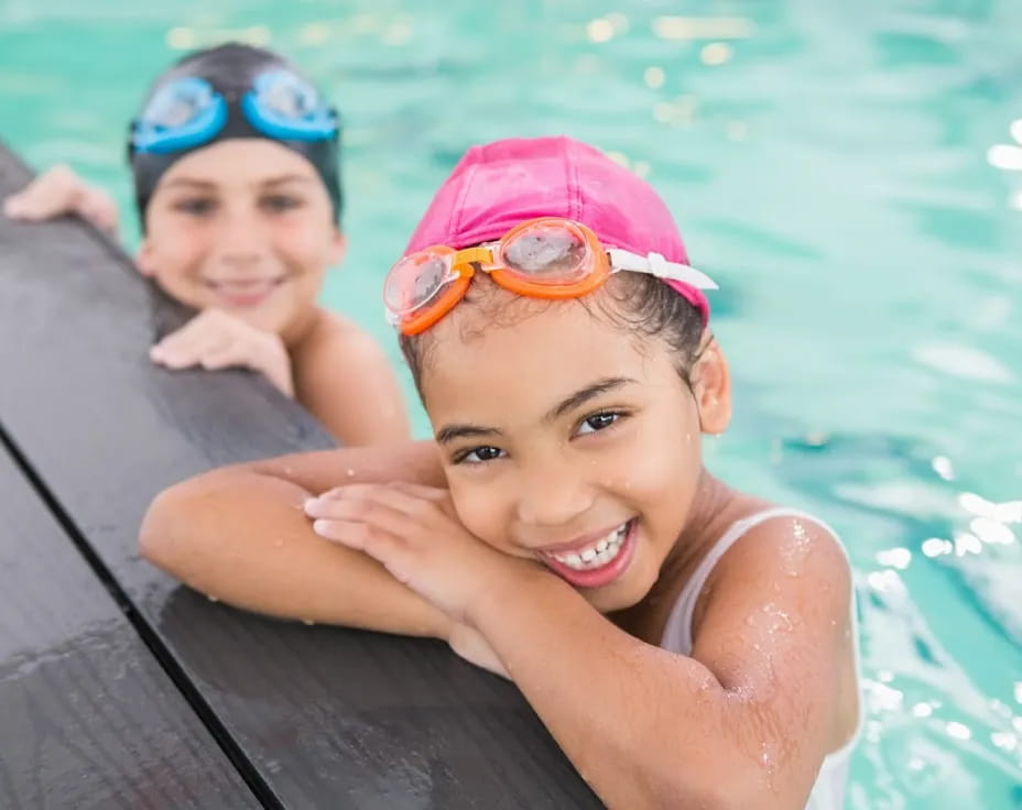 a couple of kids in a pool