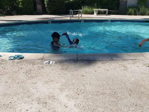 a couple of people in a pool