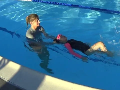 a person and a child in a pool