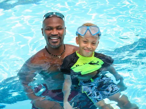a person and a boy in a pool