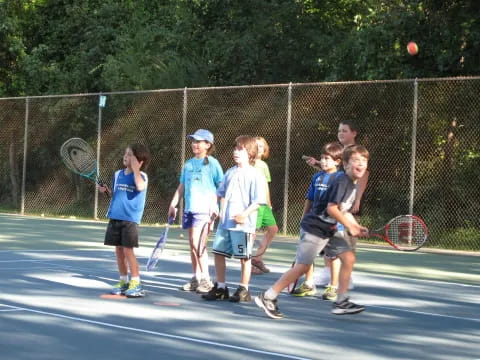 kids playing tennis on a court