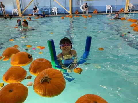 a boy in a pool with a slide