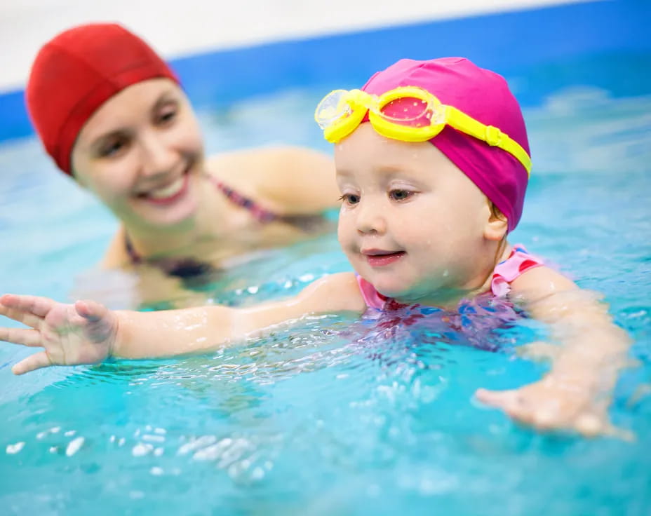 a couple of kids in a pool