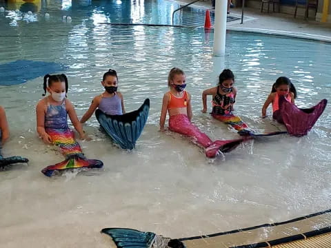 a group of kids in a pool