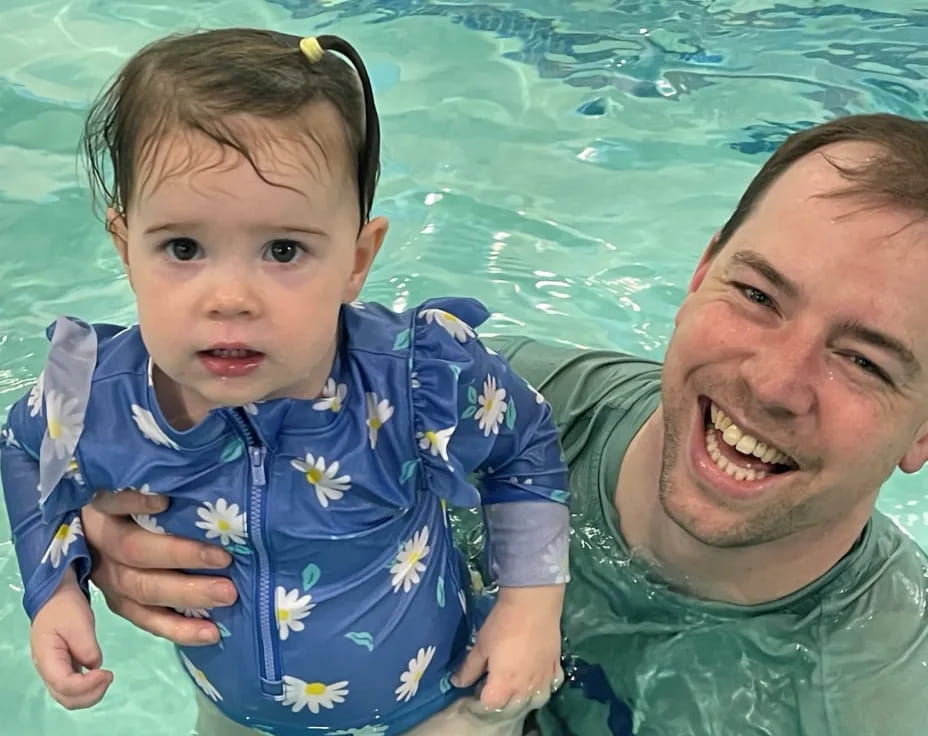 a man and a baby in a pool
