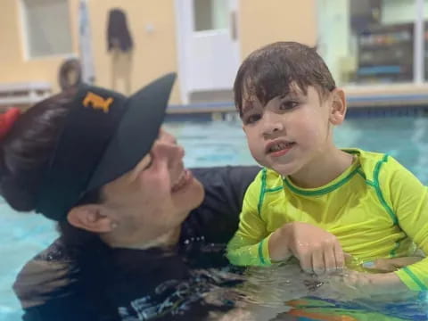 a boy and a baby in a pool