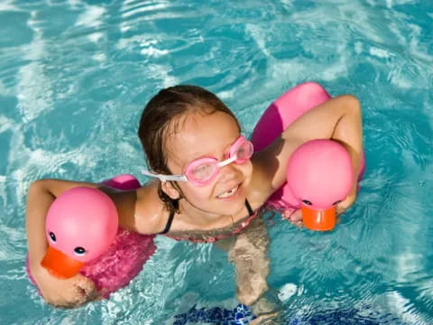 a person and a baby in a pool
