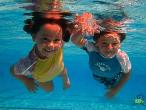 a couple of children in a pool