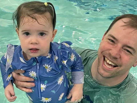 a man and a baby in a pool