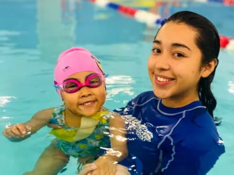 a person and a child in a pool