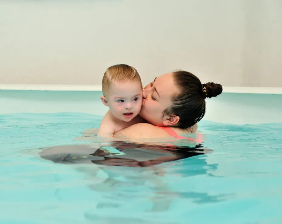 a person and a child in a pool