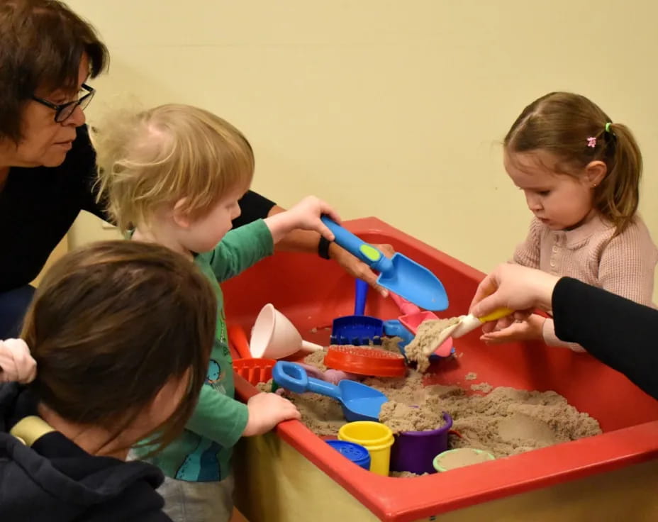 a group of children playing with sand