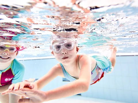 a couple of girls in a pool