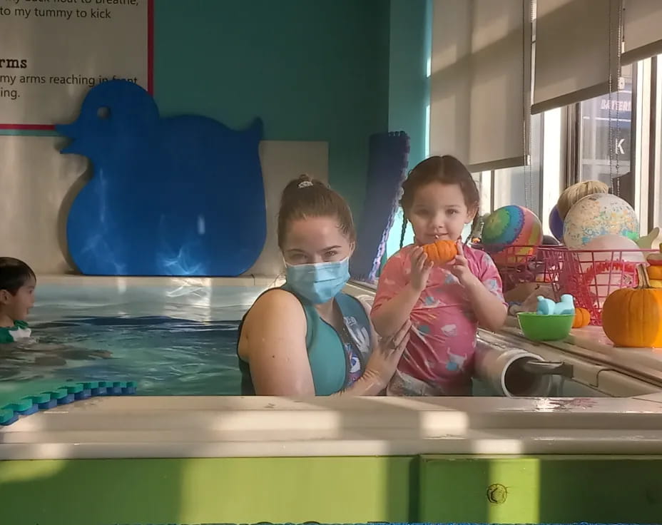 a couple of kids in a pool