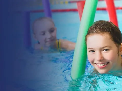 a boy and girl in a pool