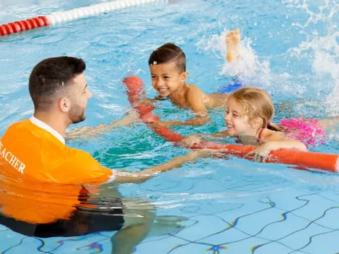 a man and a couple of children in a pool