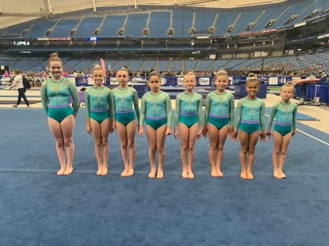 a group of women in green shirts
