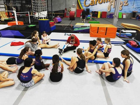 a group of people sitting on mats