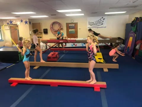 a group of children exercising in a gym