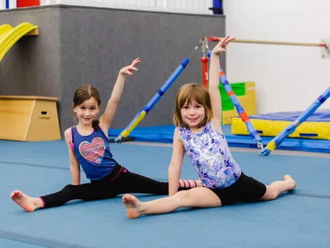 two girls on a mat