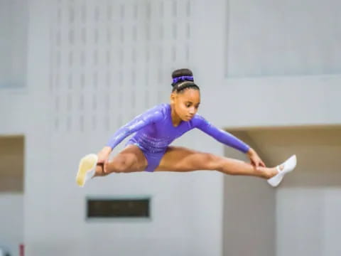 a person in a leotard jumping in the air