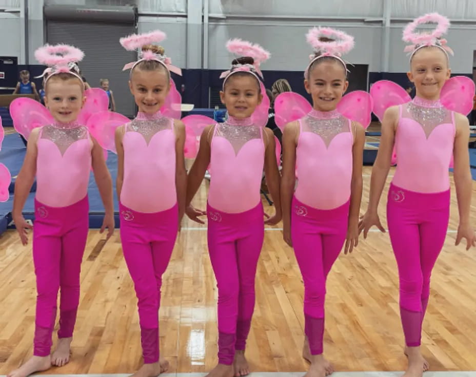 a group of girls in pink outfits