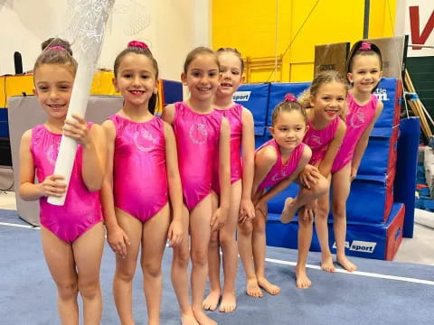 a group of girls in pink dresses