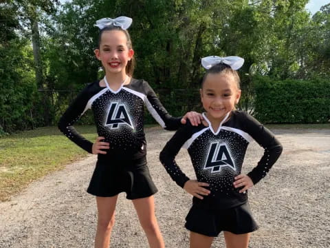 two girls wearing matching uniforms