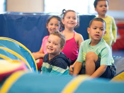 a group of children sitting on a slide