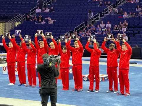 a group of people in red outfits