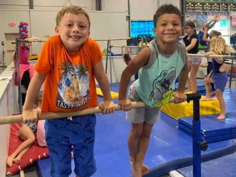 a couple of boys playing on a trampoline