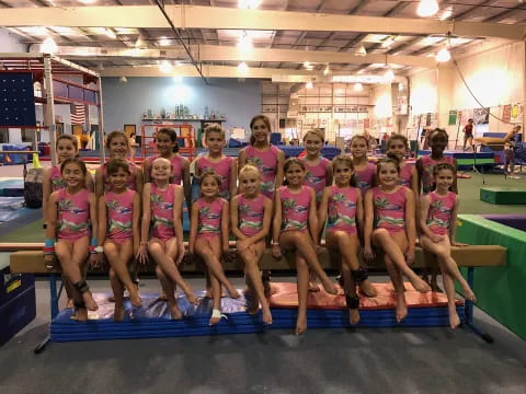 a group of girls in pink shirts