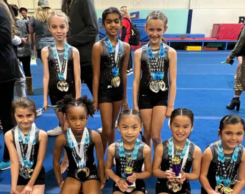 a group of girls wearing medals