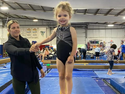 a person and a child in a gym