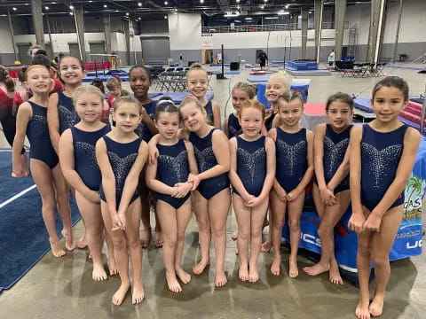 a group of girls in swimsuits posing for a photo