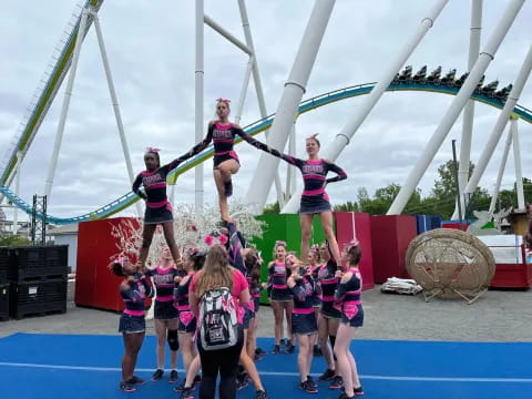 a group of cheerleaders on a blue and white track