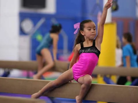 a girl in a leotard on a bench