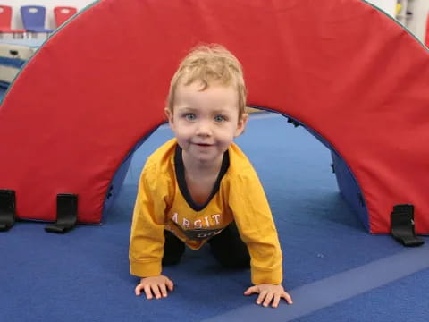 a boy sitting in a tent