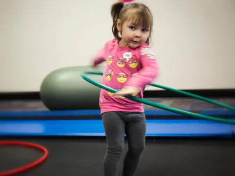 a girl holding a green ribbon