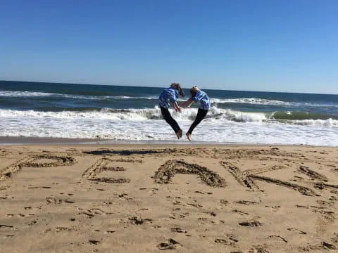 two people running on a beach