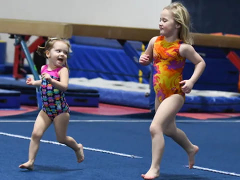 two girls running on a track