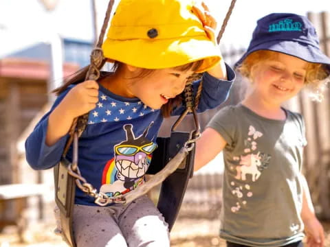 a couple of kids wearing hats