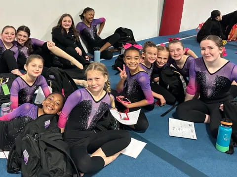 a group of women in purple shirts