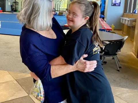 a woman kissing another woman