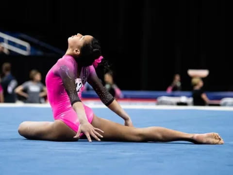 a woman in a leotard on a mat