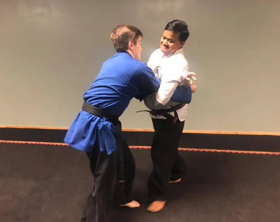 a man holding another man's waist