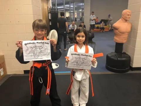 a couple of kids holding signs